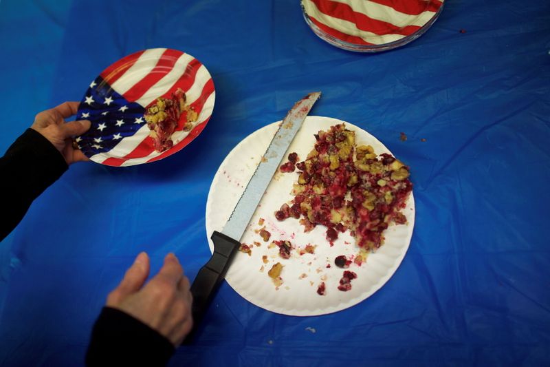 FILE PHOTO: Volunteer Scerbo places a piece of cranberry cake