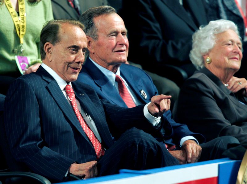 FILE PHOTO: Bob Dole sits with former President Bush and
