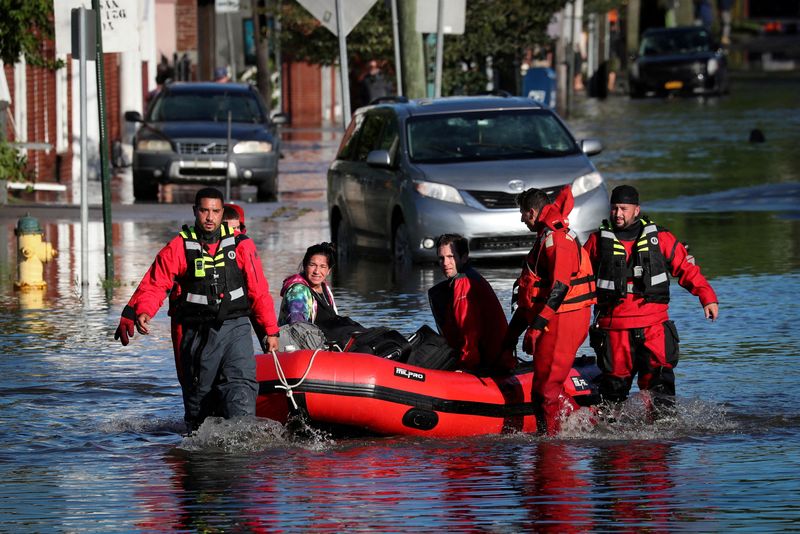 FILE PHOTO: First responders pull residents in a boat following