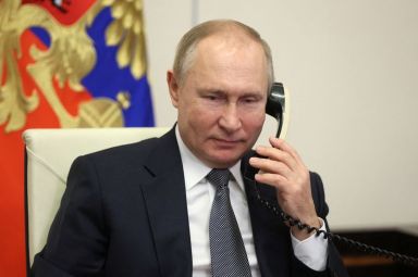 Russian President Vladimir Putin speaks on the phone at his