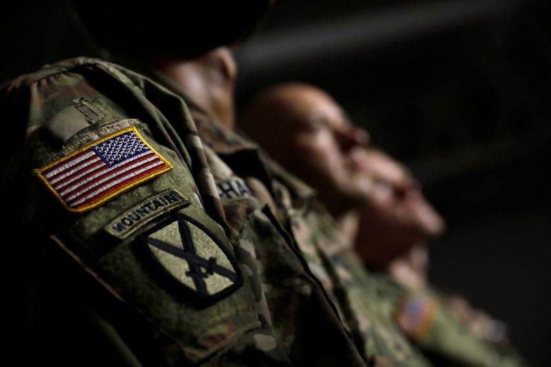 U.S. Army soldiers listen as President Trump speaks before signing