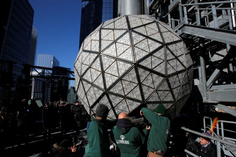 Workers install Waterford Crystal triangles on the Times Square New
