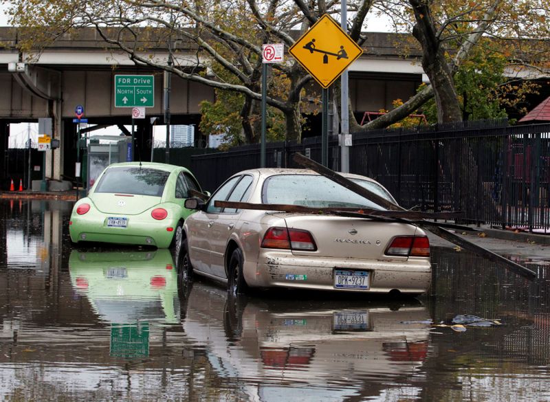FILE PHOTO: Parked cars are partially submerged in flood waters