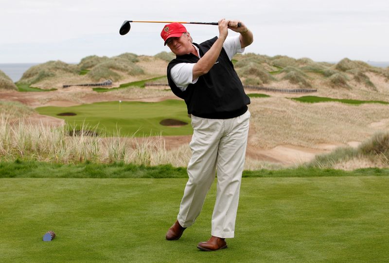 FILE PHOTO: U.S. property magnate Donald Trump practices his swing