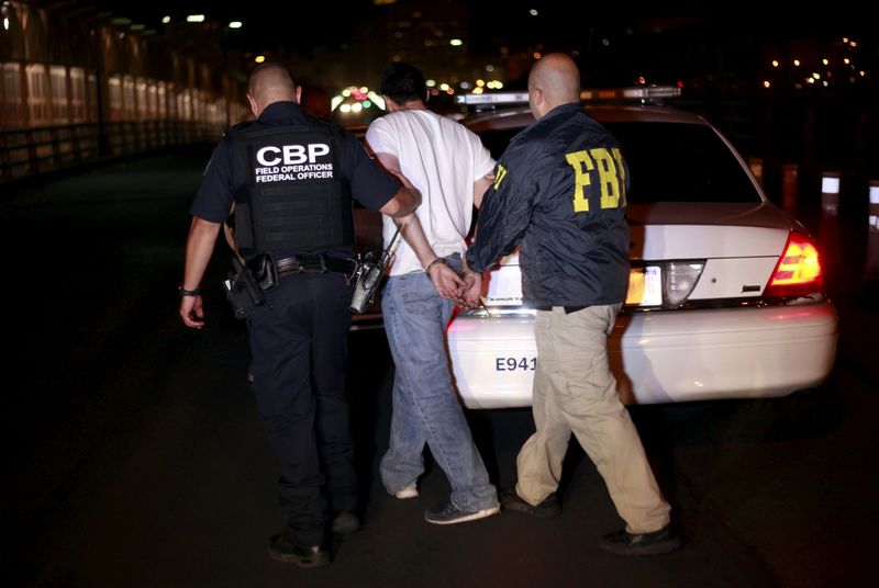 FILE PHOTO: U.S. federal agents escort a suspect at Reforma