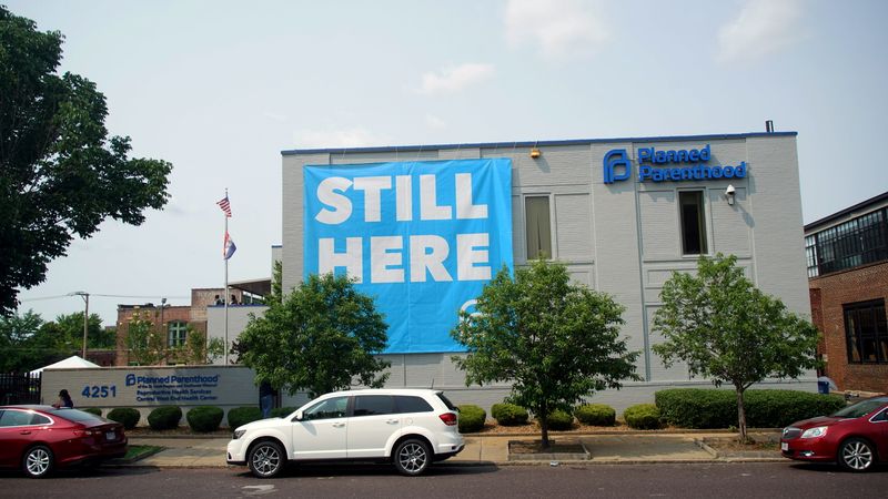 FILE PHOTO: A banner stating “STILL HERE” hangs on the