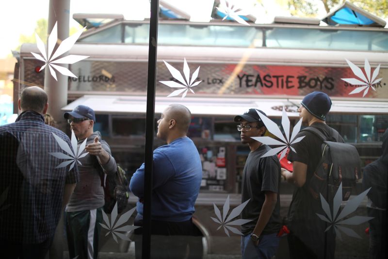 FILE PHOTO: Customers queue for recreational marijuana outside the MedMen