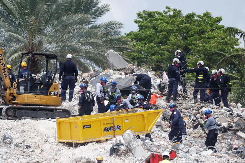 Search-and-rescue efforts resume the day after the managed demolition of
