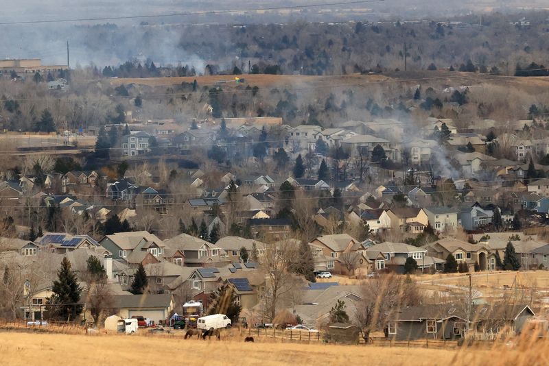 FILE PHOTO: Smoke rises a day after wind-driven wildfires prompted