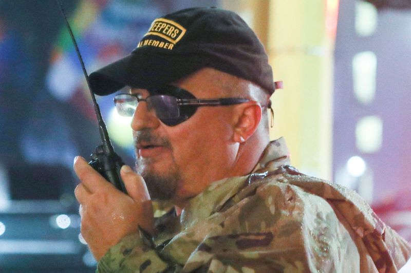 Stewart Rhodes of the Oath Keepers uses a radio as