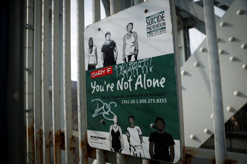 Suicide prevention sign is pictured on protective fence on the