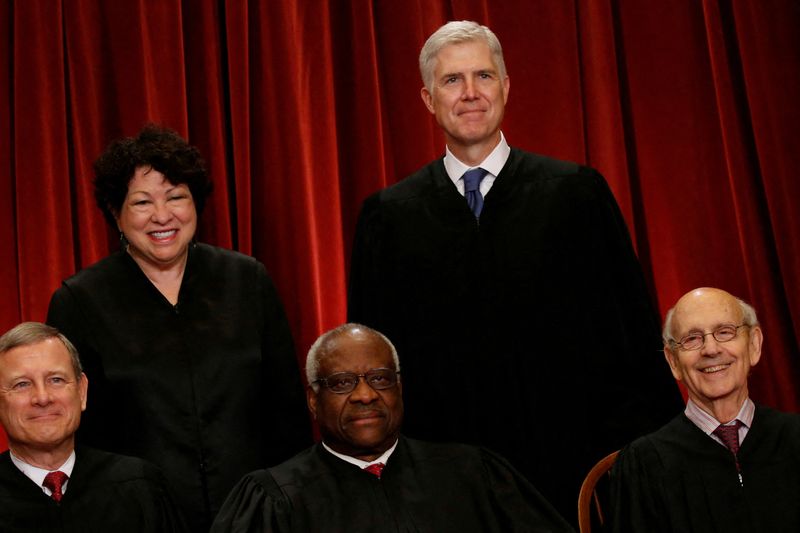 FILE PHOTO: Gorsuch smiles as he joins his fellow justices