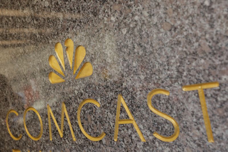 FILE PHOTO: The NBC and Comcast logos are displayed on