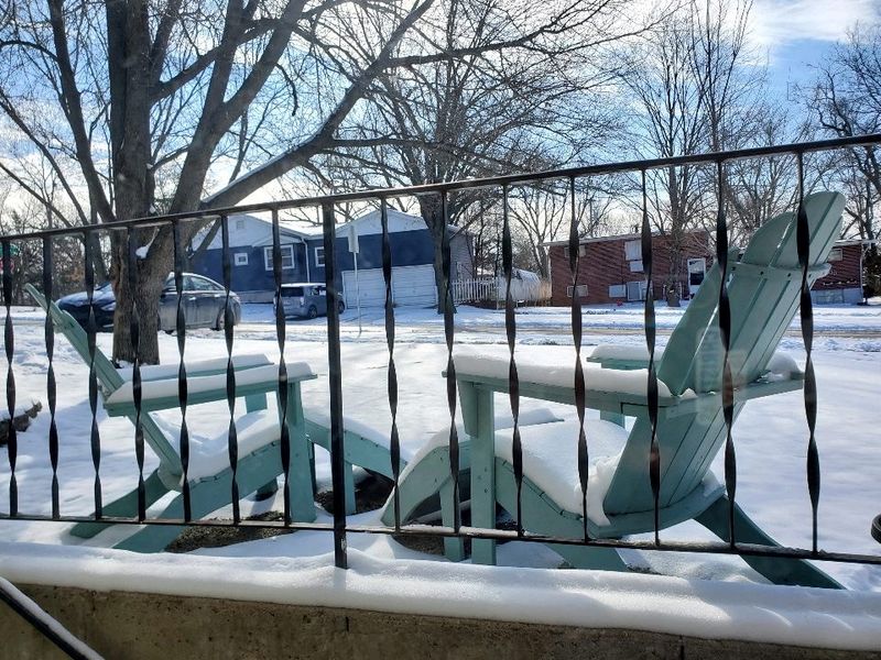 Snow blankets outdoor furniture in Lawrence, Kansas