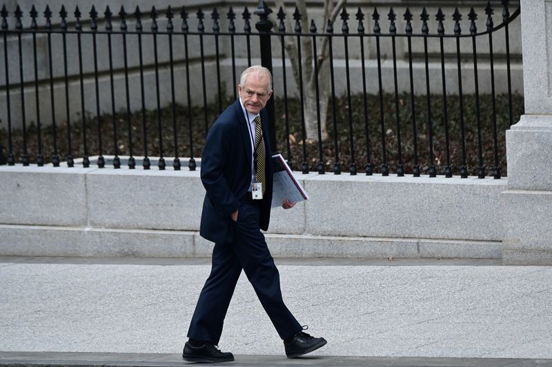 White House advisor Peter Navarro leaves the West Wing carrying