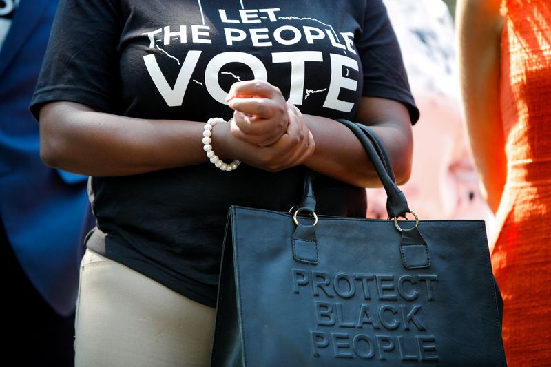 FILE PHOTO: Texas House Representative Jasmine Crockett holds her purse
