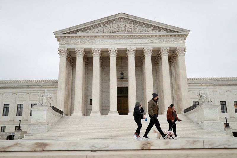 FILE PHOTO: Visitors walk along Supreme Court Plaza on Capitol