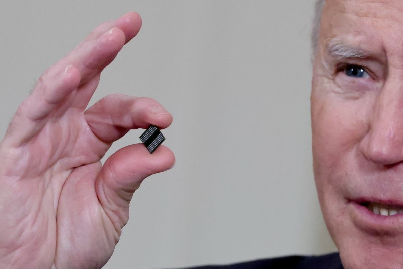 FILE PHOTO: U.S. President Biden holds a semiconductor chip