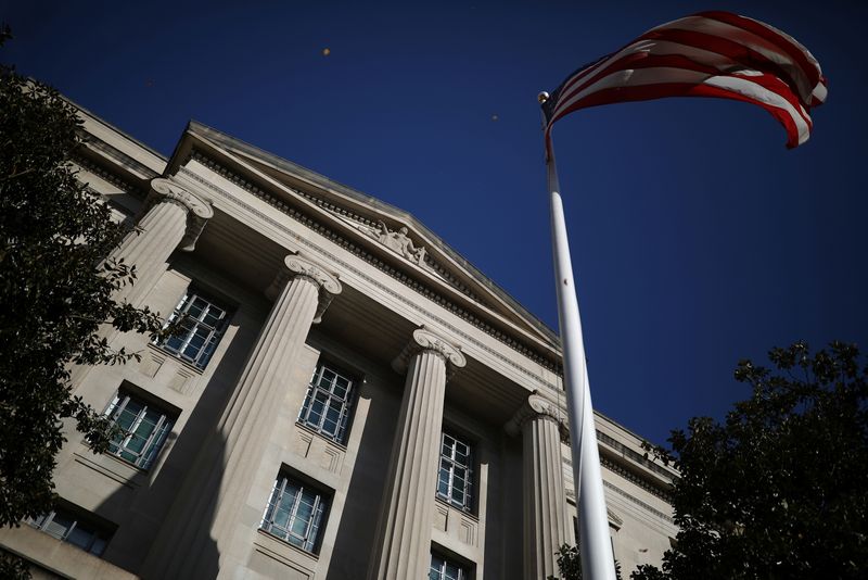 American flag waves outside the U.S. Department of Justice Building