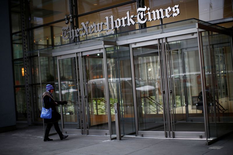 A woman walks into the New York Times building in