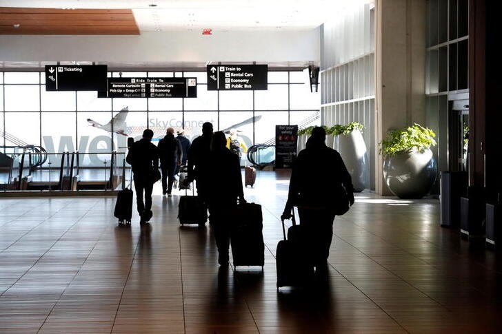 FILE PHOTO: Airline passengers walk inside the Tampa International Airport