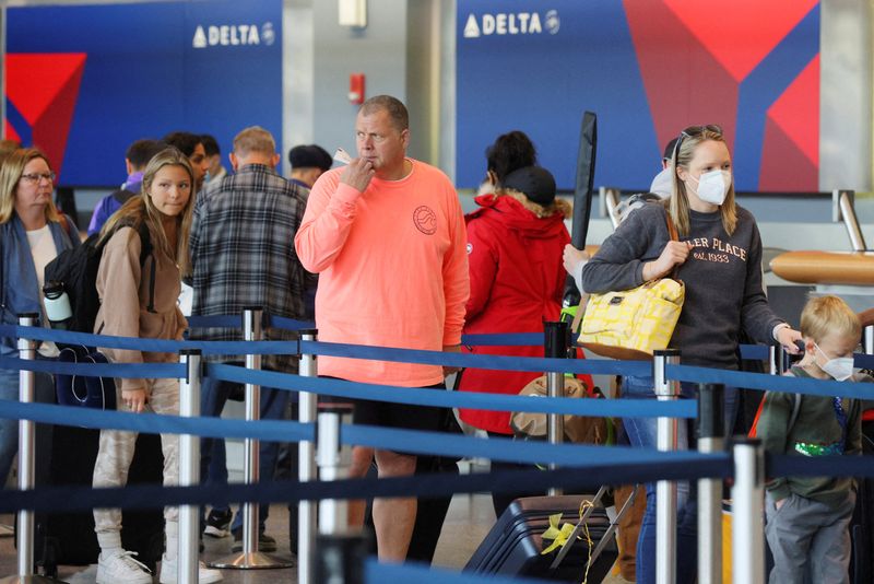 FILE PHOTO: Travellers at Logan Airport after mask mandate struck