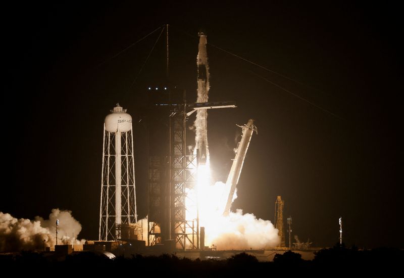 A SpaceX Falcon 9 rocket lifts off carrying four astronauts