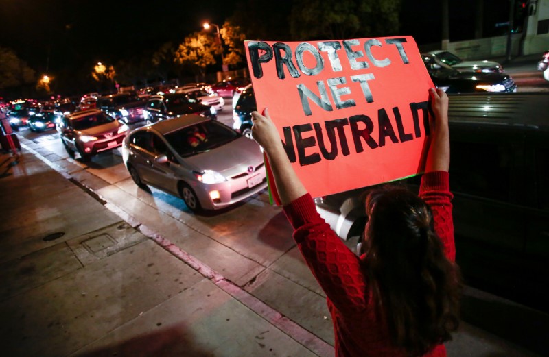 A supporter of Net Neutrality protests the FCC’s recent decision