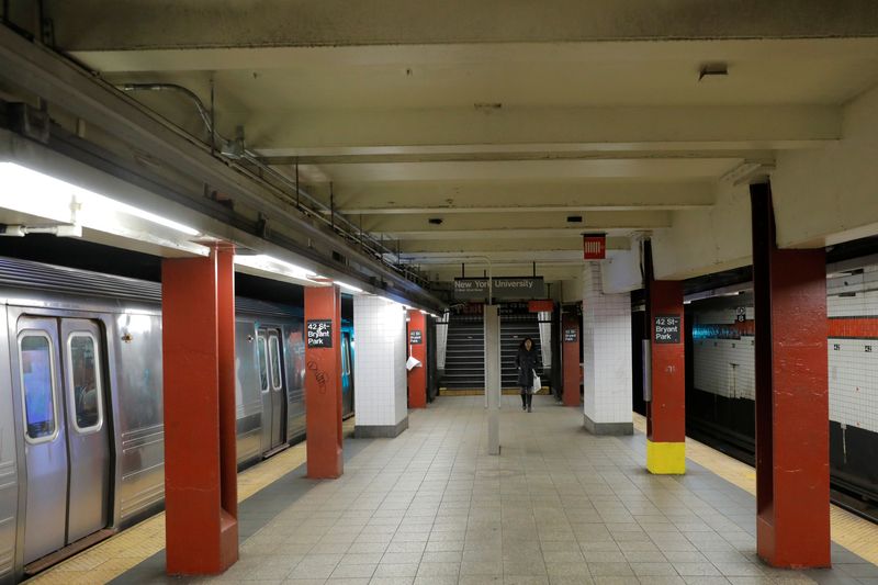 A commuter walks through the 42nd Street Bryant Park subway