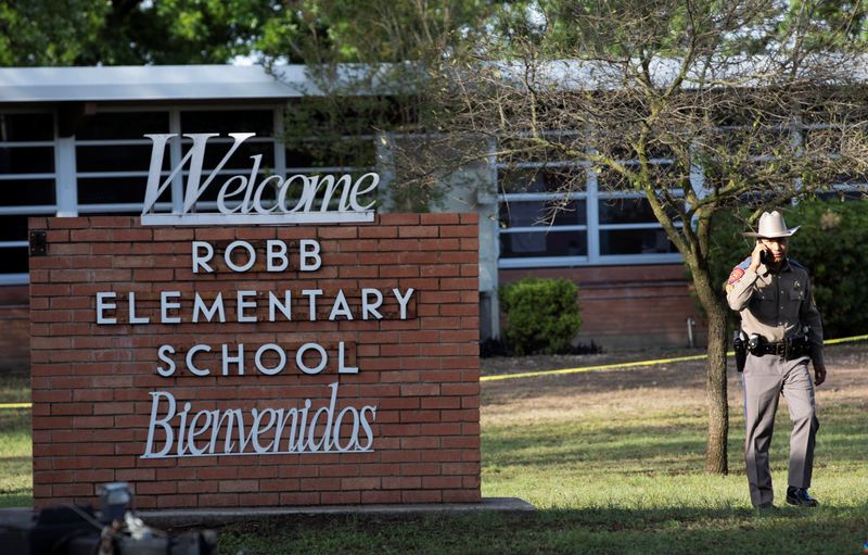 People react after a mass shooting at Robb Elementary School