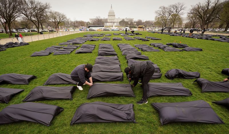 FILE PHOTO: Gun control activists place body bags on the