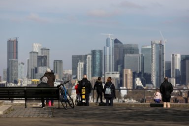 FILE PHOTO: People look out onto the Canary Wharf district