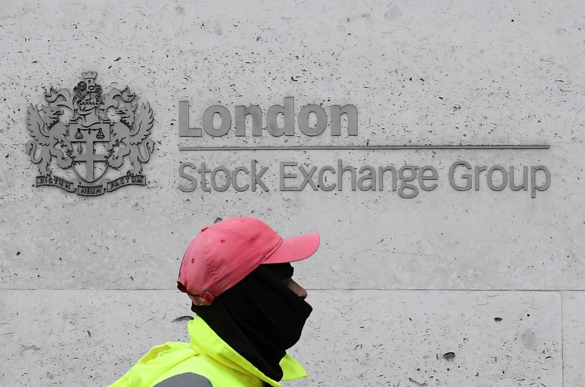 A street cleaning operative walks past the London Stock Exchange