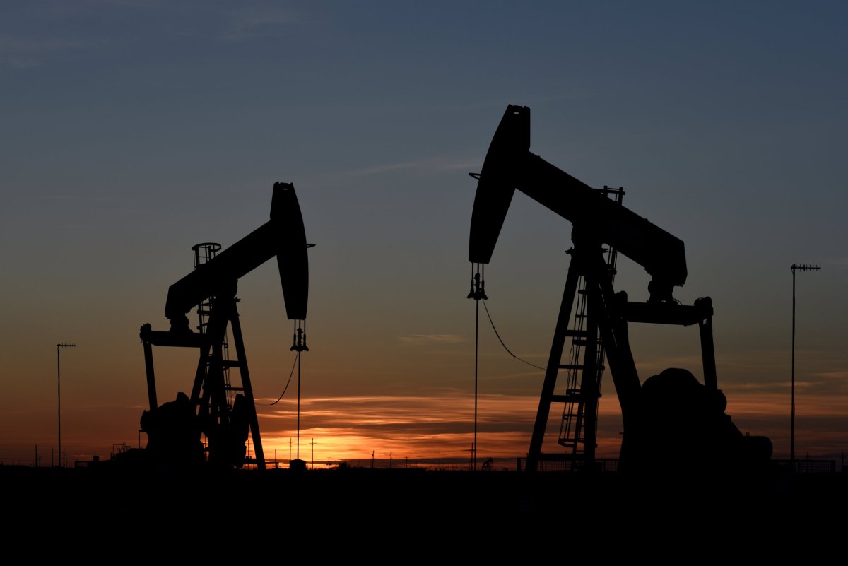 FILE PHOTO: Pump jacks operate at sunset in an oil