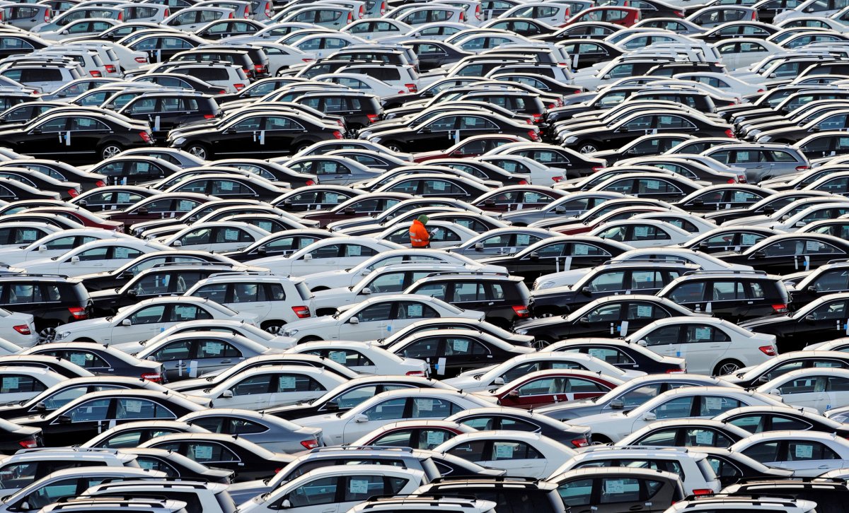 FILE PHOTO:  A worker walks along rows of Mercedes