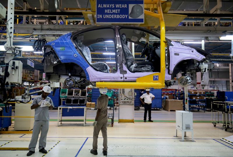 FILE PHOTO: Workers assemble a Tata Tigor car inside the