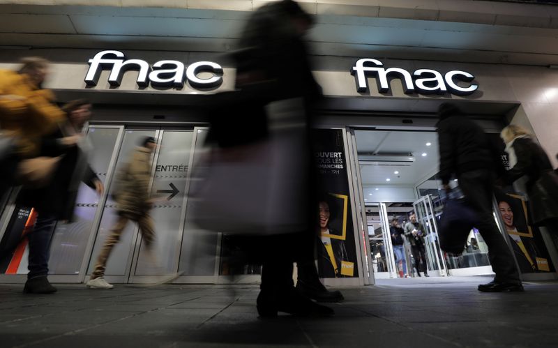 FILE PHOTO:  People walk past a Fnac retail store