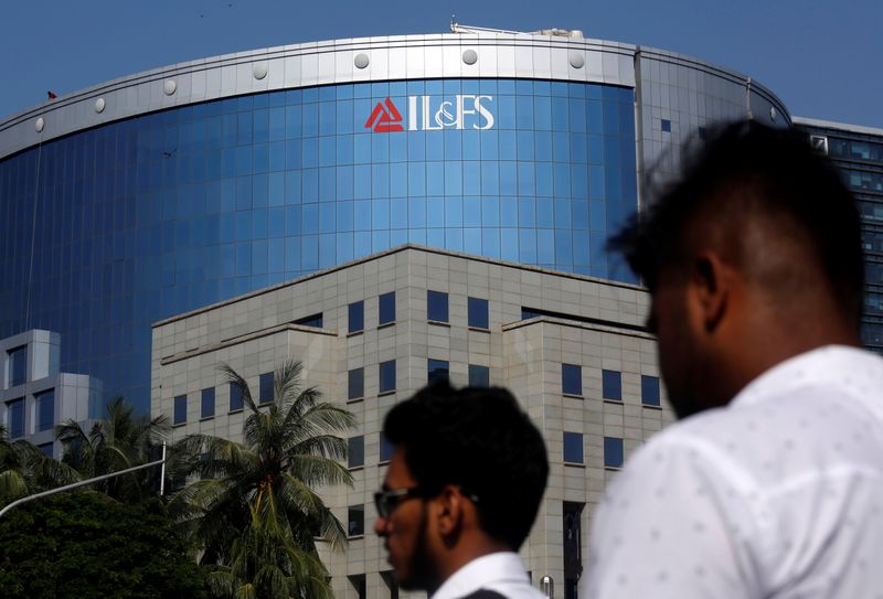 People walk past a building of IL&FS outside its headquarters