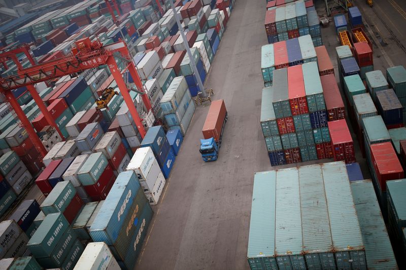 FILE PHOTO: A truck drives between shipping containers at a