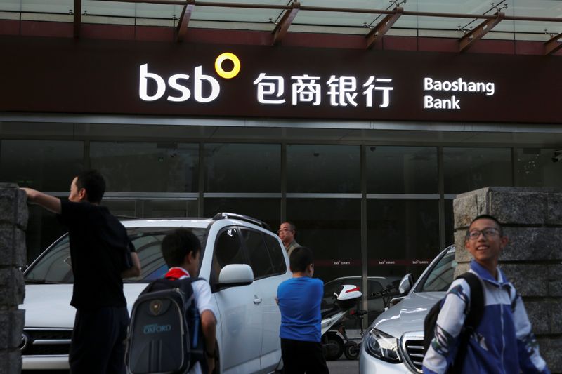 People walk past a branch of Baoshang Bank in Beijing