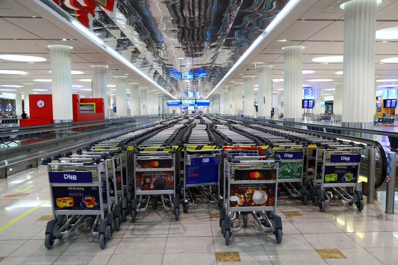 Empty trolleys are seen at Dubai International Airport, as Emirates