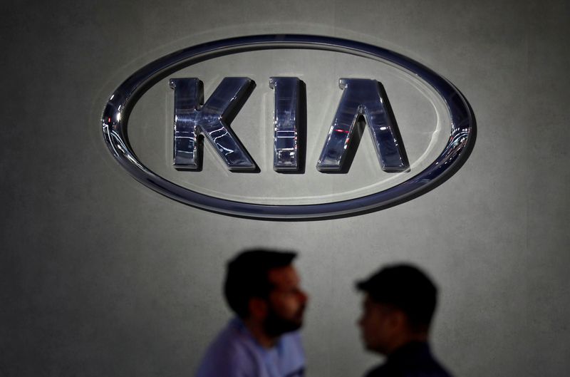 FILE PHOTO: Visitors walk past the logo of Kia Motors