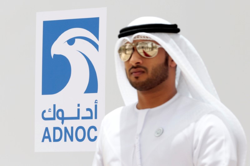 An Emirati man is seen near the logo of