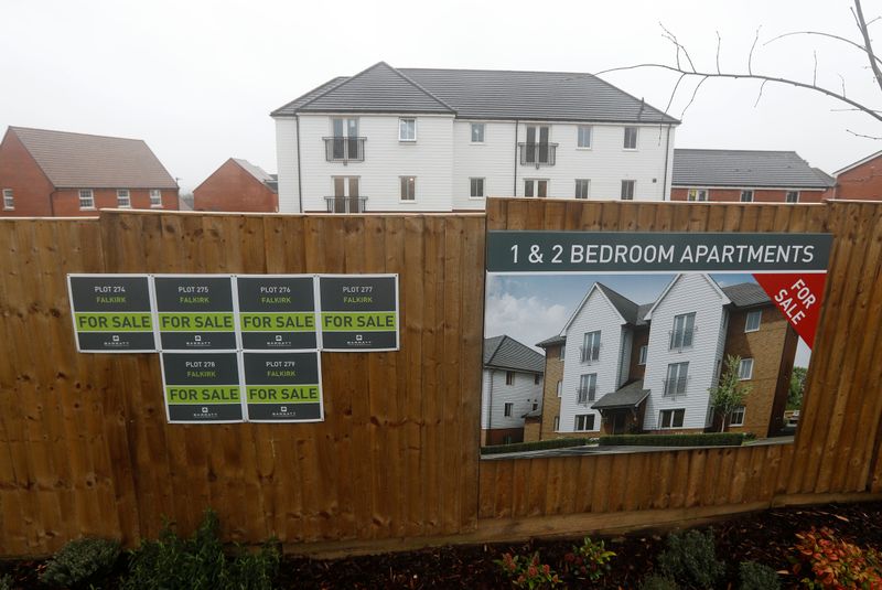 Newly built properties and “for sale” signs are seen at