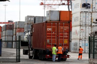 FILE PHOTO: A truck carrying a container enters at Lisbon’s