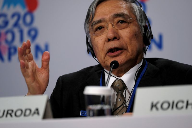 FILE PHOTO: Bank of Japan Governor Haruhiko Kuroda takes questions