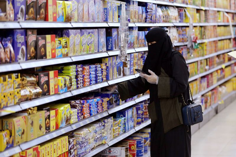 FILE PHOTO: A Saudi woman wearing protective gloves shops at