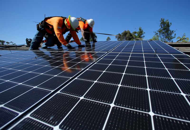 FILE PHOTO: Solar installers from Baker Electric place solar panels