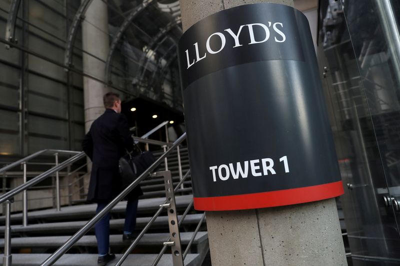 FILE PHOTO: A worker enters the Lloyd’s of London building