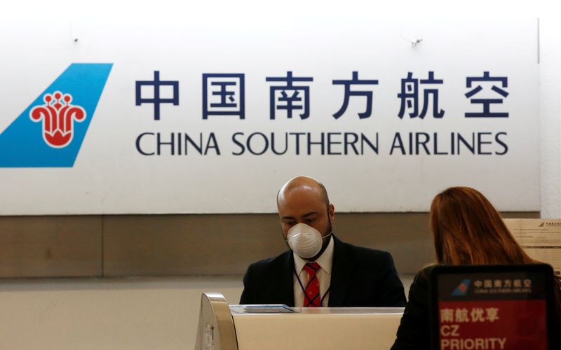 FILE PHOTO: A China Southern Airlines employee wears a surgical